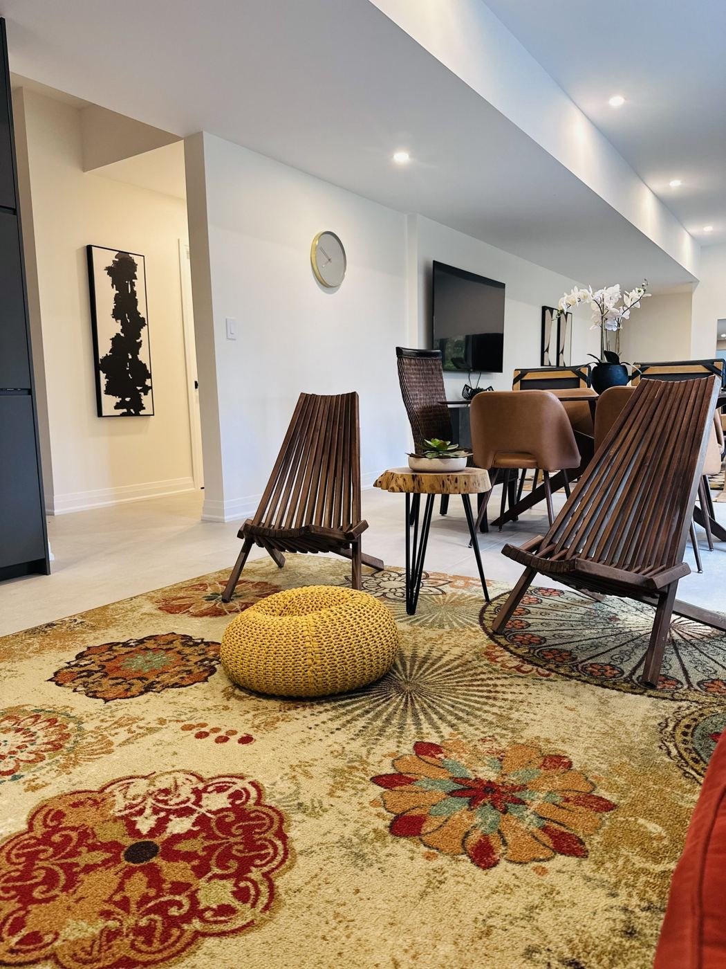 Lounge chairs and dining table on a patterned rug